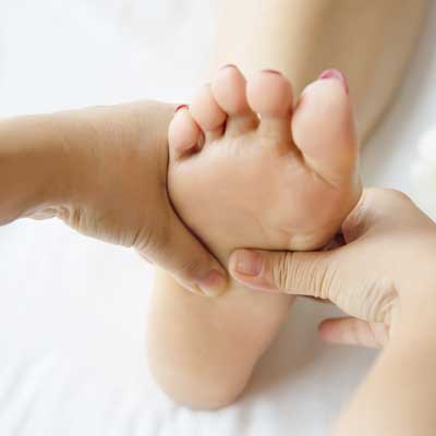 Reflexologist treating patient